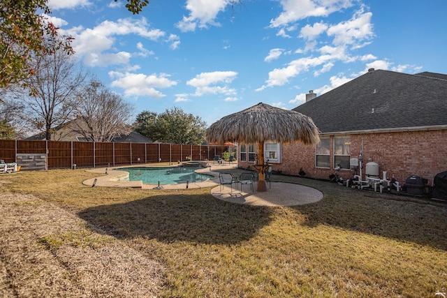 view of pool featuring a lawn and a patio