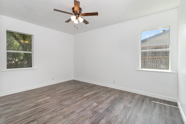 empty room with ceiling fan and dark hardwood / wood-style floors