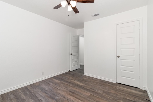 unfurnished room featuring ceiling fan and dark hardwood / wood-style flooring