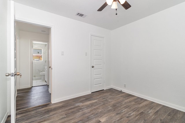 unfurnished room featuring ceiling fan and dark wood-type flooring