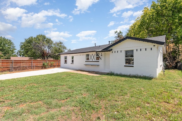 back of house with a yard