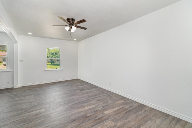 unfurnished room with ceiling fan and dark hardwood / wood-style floors