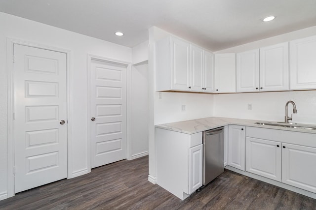 kitchen featuring dark wood-type flooring, white cabinets, dishwasher, and sink