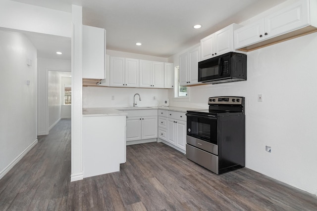 kitchen with sink, white cabinetry, dark hardwood / wood-style flooring, and stainless steel electric range