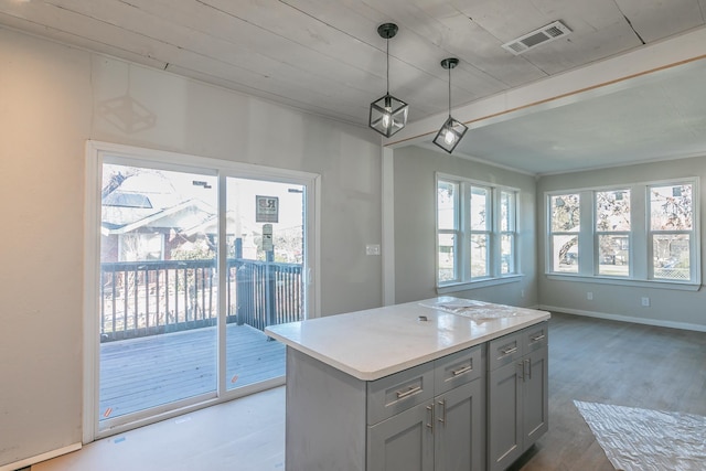 kitchen with decorative light fixtures, wood ceiling, gray cabinets, and a kitchen island