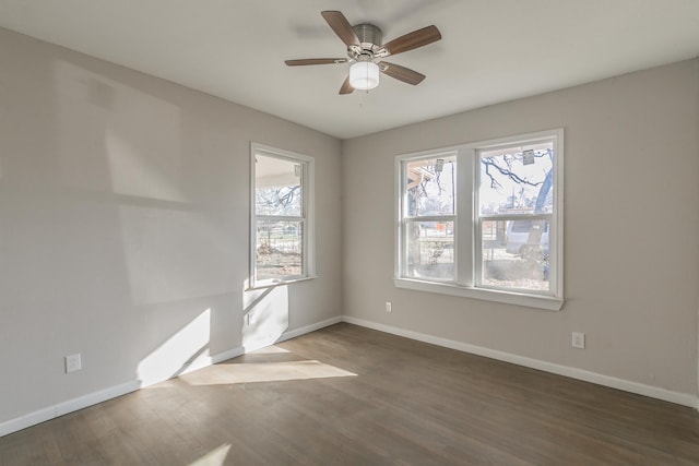 spare room with ceiling fan, plenty of natural light, and dark hardwood / wood-style floors