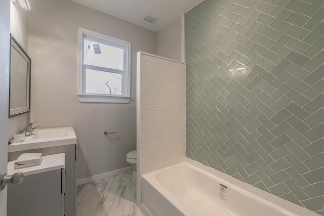 full bathroom featuring toilet, vanity, and tiled shower / bath