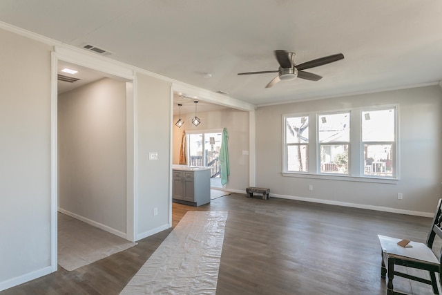 living room featuring ceiling fan, dark hardwood / wood-style flooring, and crown molding