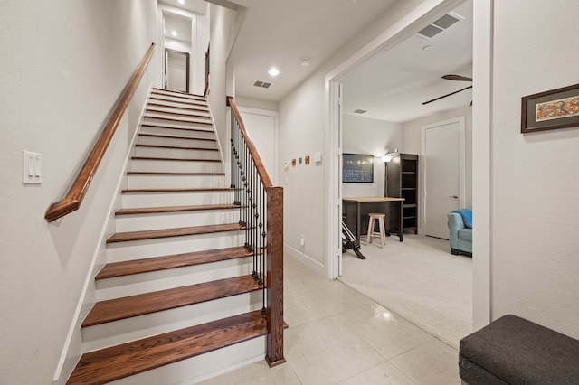 living room with light colored carpet, visible vents, a ceiling fan, and baseboards