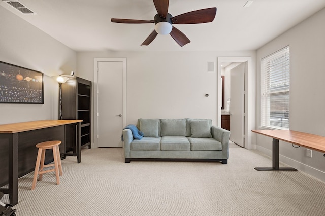 4211 Rawlins St Unit 733, Dallas, TX 75219 - living room featuring light colored carpet, a ceiling fan, and baseboards