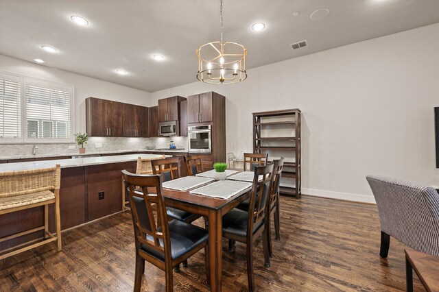 4211 Rawlins St Unit 733, Dallas, TX 75219 - dining room with dark wood-style floors, a chandelier, recessed lighting, and baseboards
