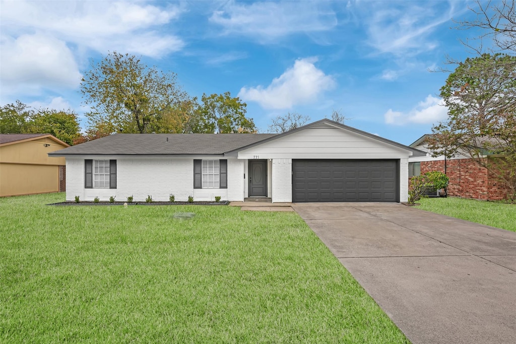 single story home with a garage and a front lawn