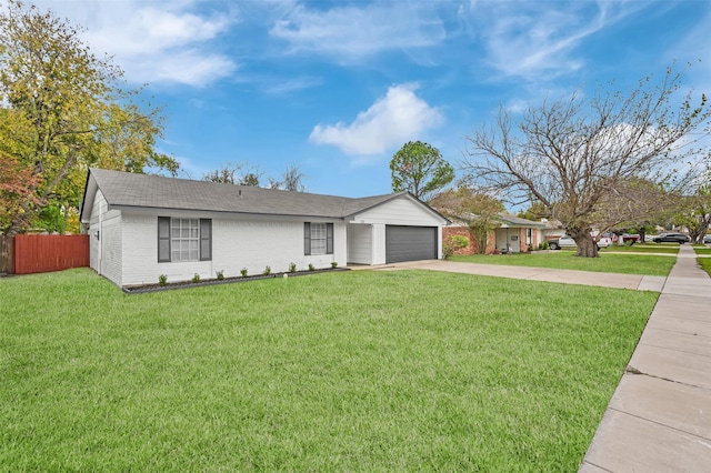 ranch-style house featuring a front lawn and a garage