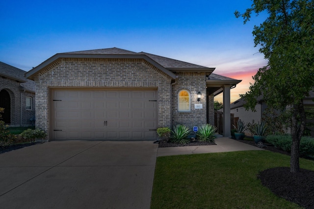 view of front of home featuring a garage and a lawn