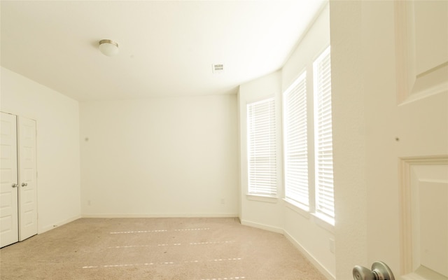 spare room with light carpet