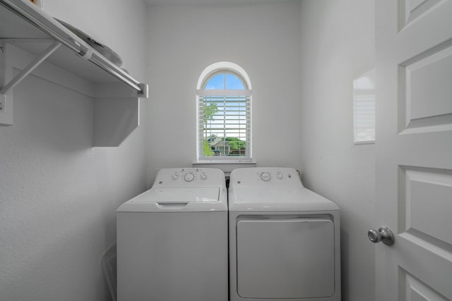 clothes washing area featuring independent washer and dryer