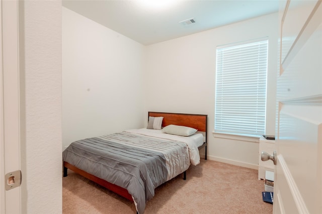 bedroom with light carpet