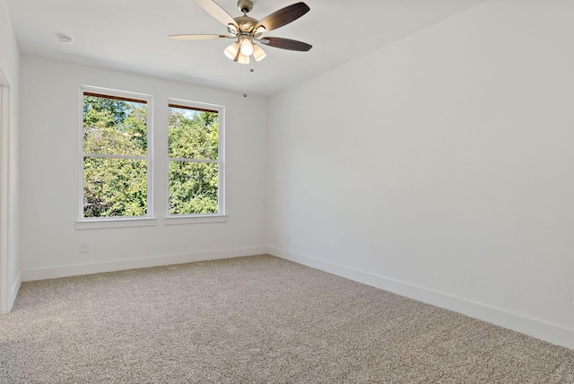 empty room with ceiling fan and carpet floors