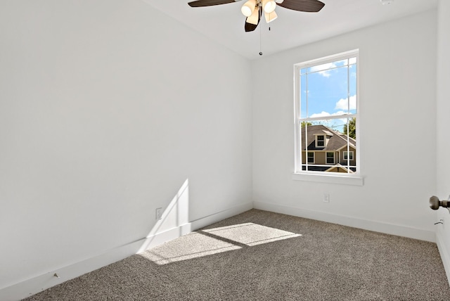 empty room featuring ceiling fan and carpet