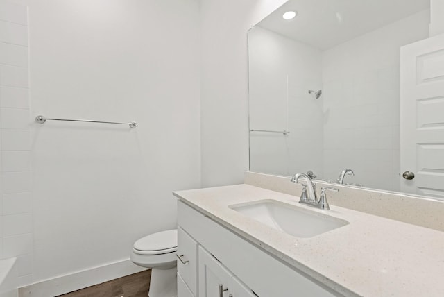 bathroom featuring toilet, hardwood / wood-style floors, and vanity