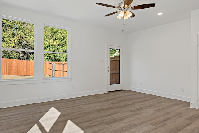 empty room with ceiling fan and hardwood / wood-style floors