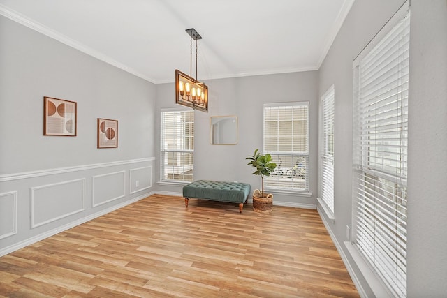 unfurnished room with a wealth of natural light, crown molding, and a chandelier