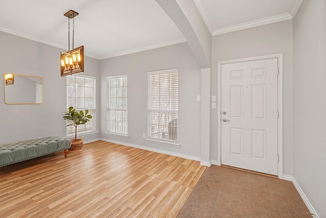 entrance foyer featuring an inviting chandelier and ornamental molding