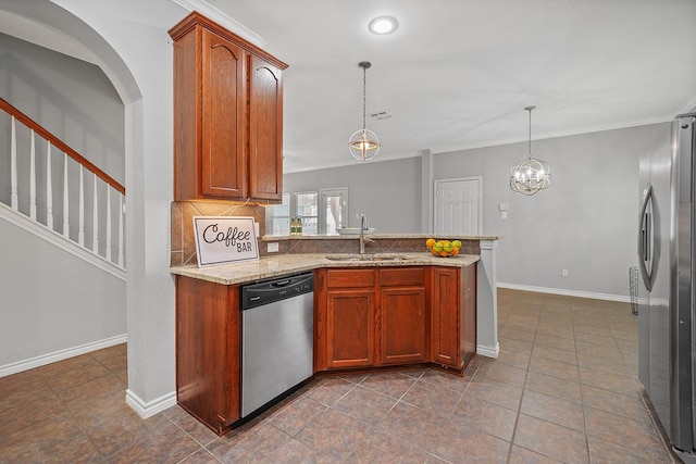 kitchen with decorative light fixtures, sink, an inviting chandelier, light stone countertops, and appliances with stainless steel finishes