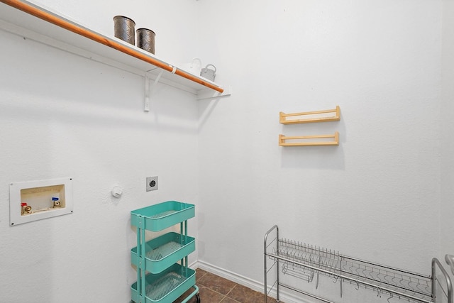 washroom with hookup for a washing machine, dark tile patterned floors, and hookup for an electric dryer