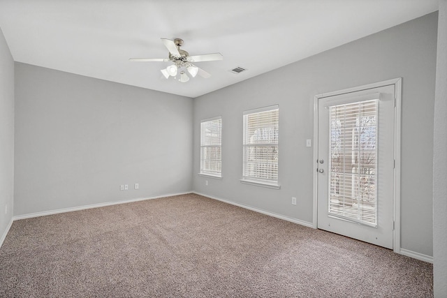 empty room with ceiling fan and carpet