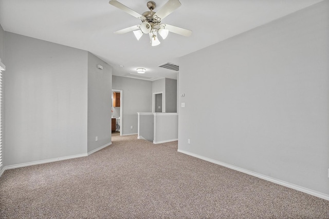 spare room featuring ceiling fan and light carpet