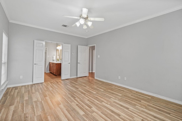 unfurnished bedroom featuring ceiling fan, crown molding, connected bathroom, and light hardwood / wood-style floors