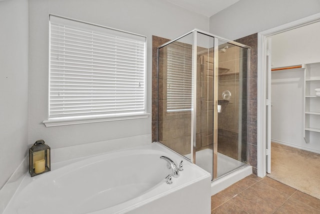 bathroom featuring tile patterned flooring and shower with separate bathtub