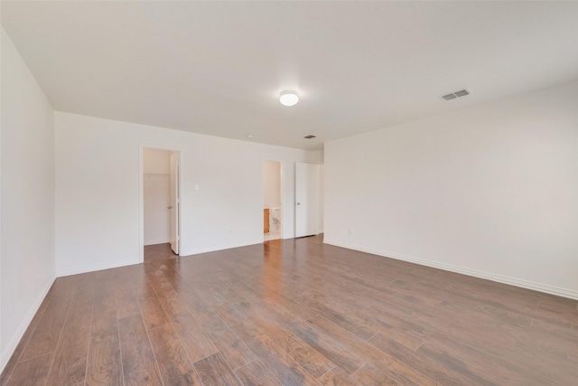 spare room with dark wood-type flooring