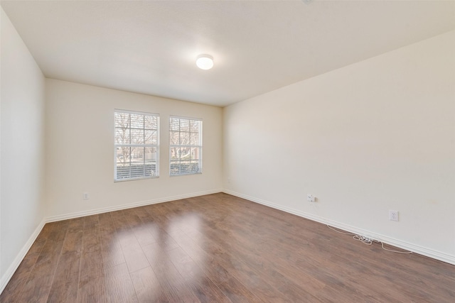 spare room with dark hardwood / wood-style floors