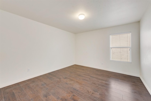 empty room with dark wood-type flooring