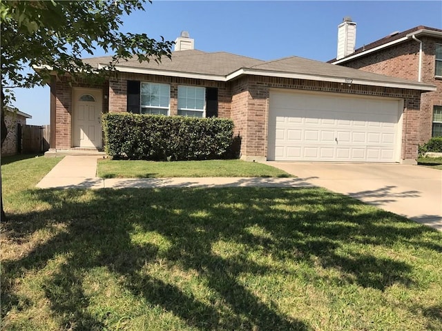 view of front of property featuring a front yard and a garage