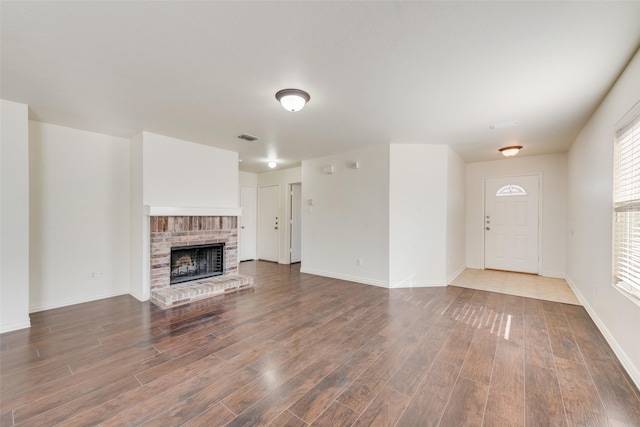 unfurnished living room with a fireplace and hardwood / wood-style flooring