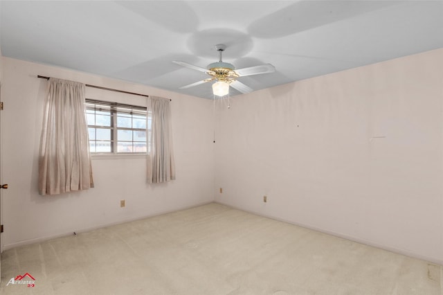 spare room featuring light carpet and ceiling fan