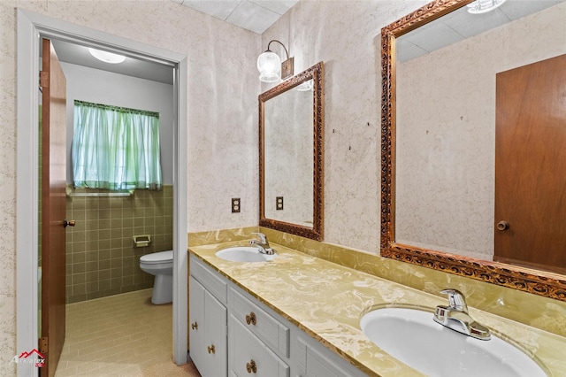 bathroom featuring toilet, vanity, and tile patterned floors