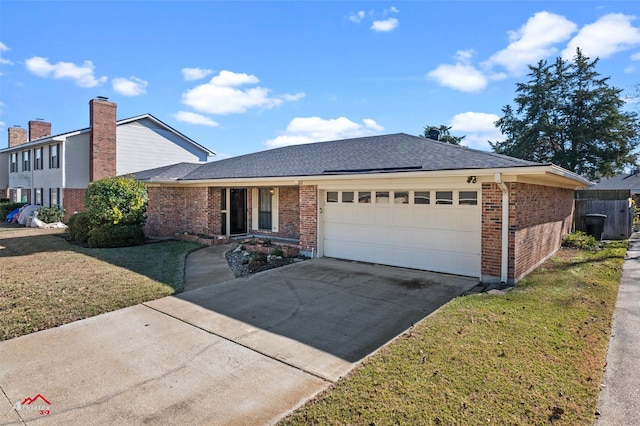 view of front facade featuring a front yard and a garage