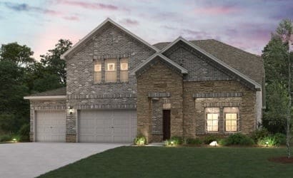 view of front of house featuring a garage and a yard