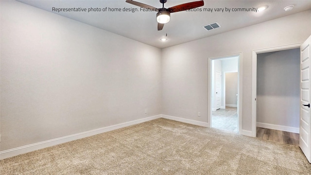 carpeted spare room with ceiling fan