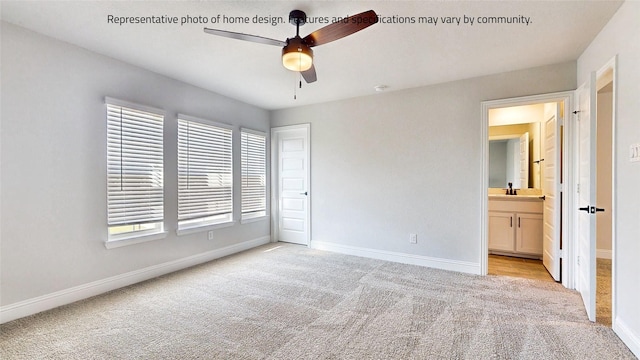 unfurnished bedroom with ceiling fan, ensuite bathroom, light colored carpet, and sink