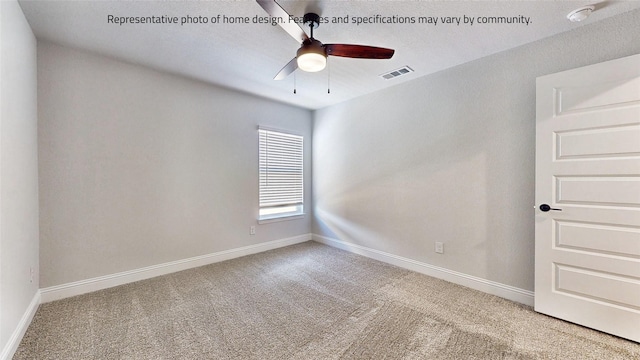 carpeted spare room with ceiling fan