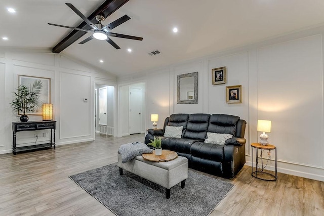 living room featuring ceiling fan, lofted ceiling with beams, and light hardwood / wood-style floors