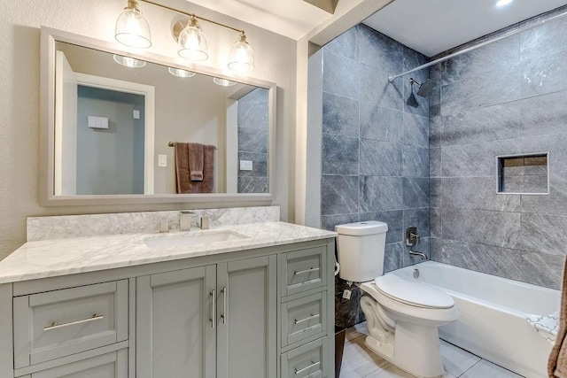 full bathroom with tile patterned floors, toilet, vanity, and tiled shower / bath