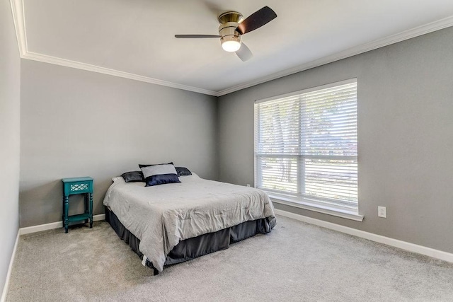 carpeted bedroom featuring ceiling fan and ornamental molding