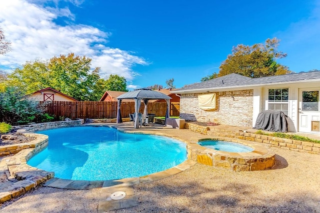 view of pool with an in ground hot tub, a patio area, and a gazebo