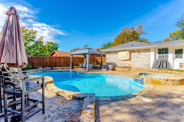 view of pool featuring a patio area, a gazebo, and an in ground hot tub